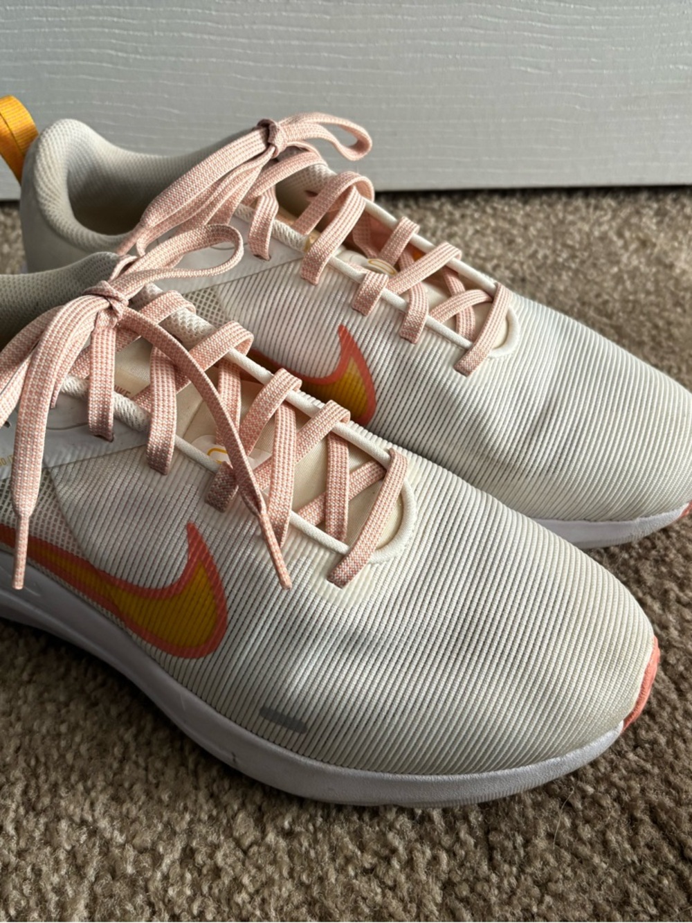 Nike Women's Cream Running Sneakers with Pink Laces and Yellow-to-Pink Swoosh
